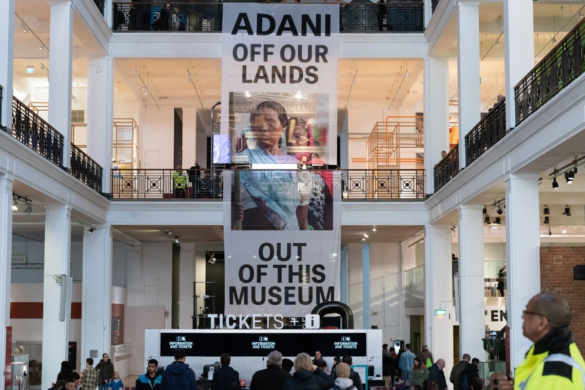 Banner reading "Adani off our lands , out of this museum" hanging from the Science Museum's gallery. Photo: Ron Fassbender